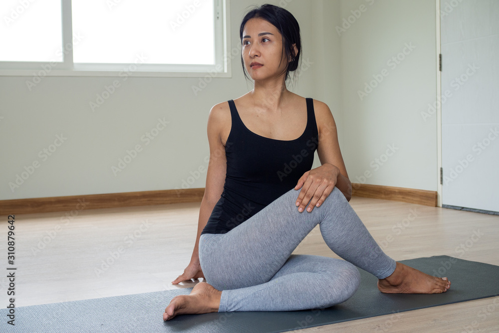 Women are doing seated twist exercises for health and a firmer body. yoga concept Women are doing seated twist exercises for health and a firmer body. yoga concept