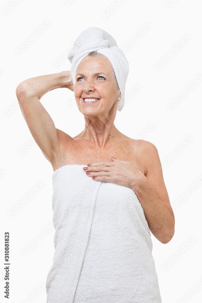 Senior woman wrapped in towels against white background Senior woman wrapped in towels against white background
