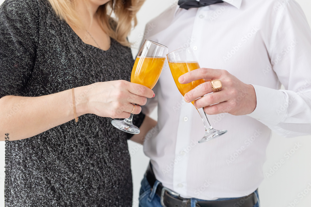 Holidays, christmas, valentine's day and new year concept - Woman and man celebrate and holds wine in a glass close-up over white background Holidays, christmas, valentine's day and new year concept - Woman and man celebrate and holds wine in a glass close-up over white background