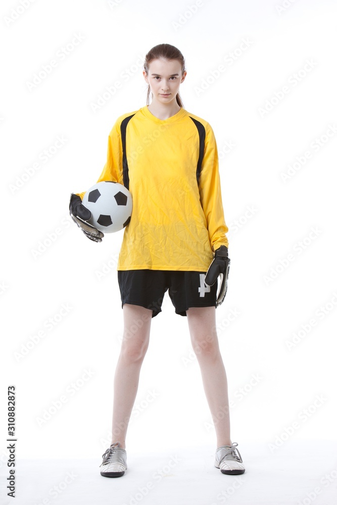 Portrait of young woman with soccer ball against white background