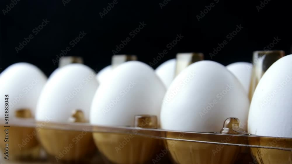 Taking of white chicken egg from box Taking of white chicken egg from box