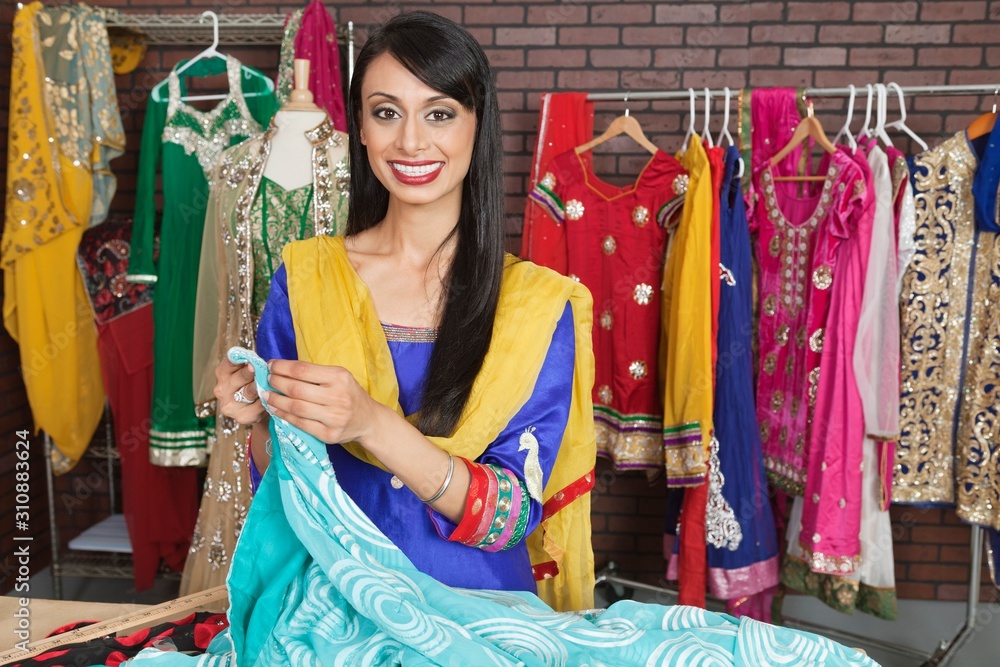 Portrait of an Indian female dressmaker working at design studio