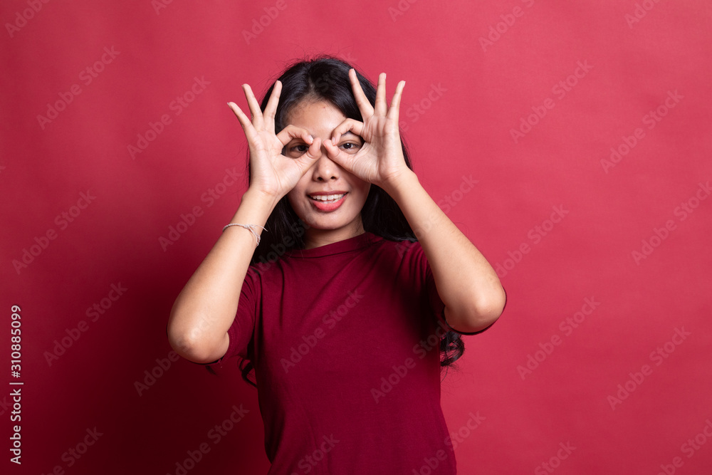 Asian woman do funny double OK sign as glasses. Asian woman do funny double OK sign as glasses.