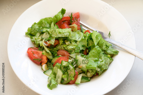 Salad with olives, tomatoes and cucumber.