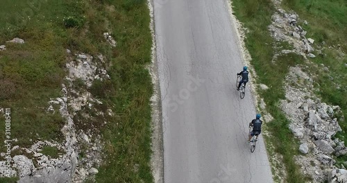 Two cyclists training and preparing themselfs for triathlon contest in the mountains photo