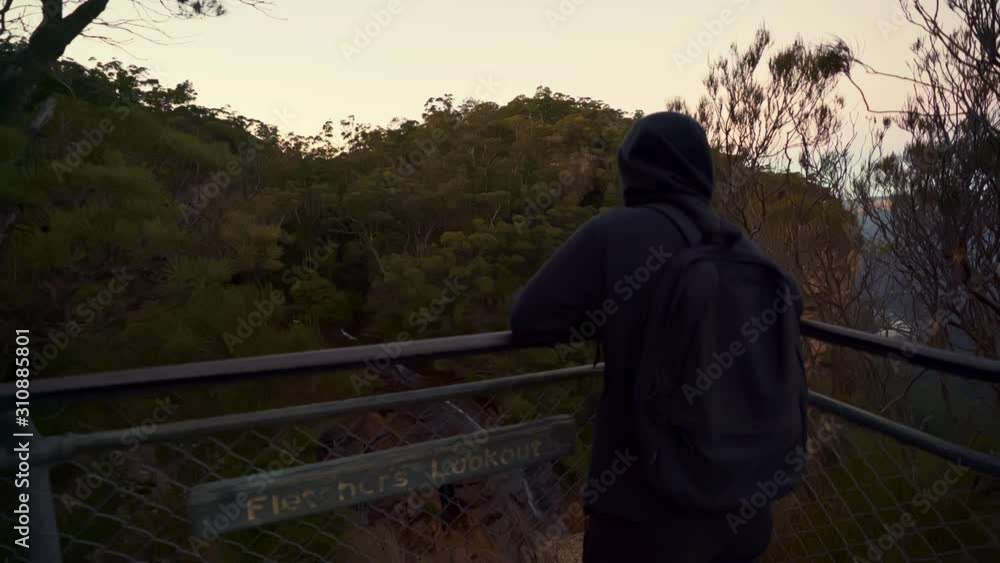 Young women moves to the edge of a very steep drop in the Blue Mountains National Park Young women moves to the edge of a very steep drop in the Blue Mountains National Park