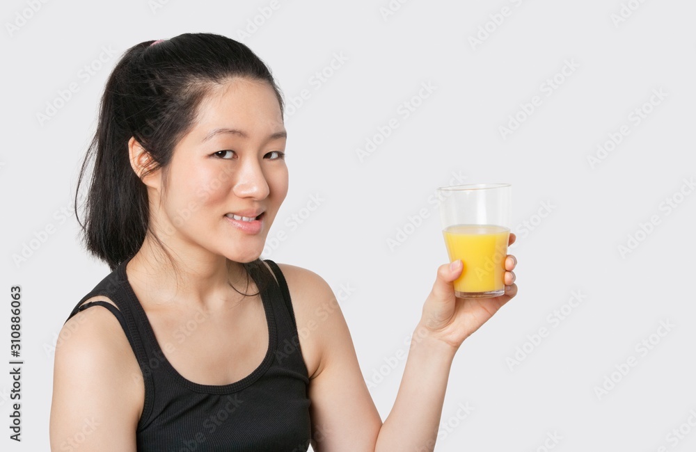 Portrait of a beautiful woman having a glass of orange juice Portrait of a beautiful woman having a glass of orange juice