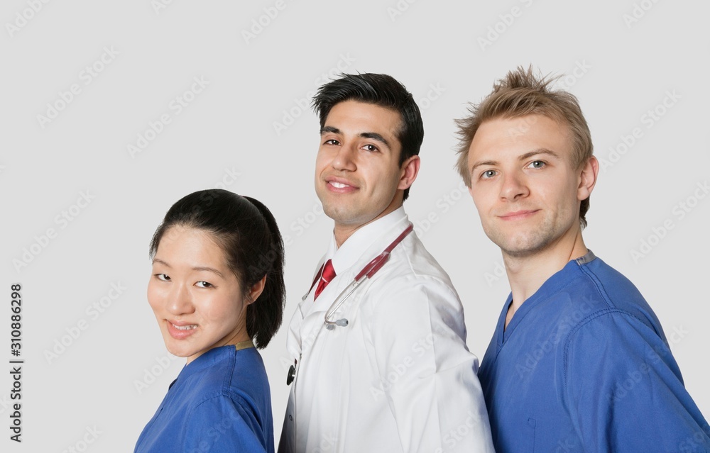 Portrait of multi ethnic medical team over gray background Portrait of multi ethnic medical team over gray background