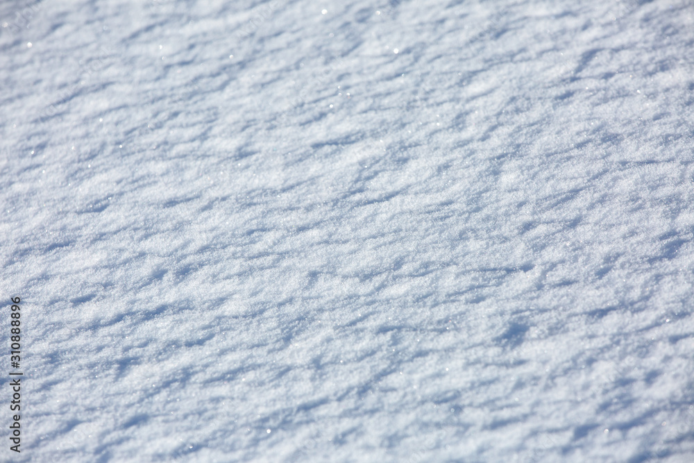 Snow surface as background or texture. Snow background with sparkling snowflakes for a winter theme. Snow surface as background or texture. Snow background with sparkling snowflakes for a winter theme.