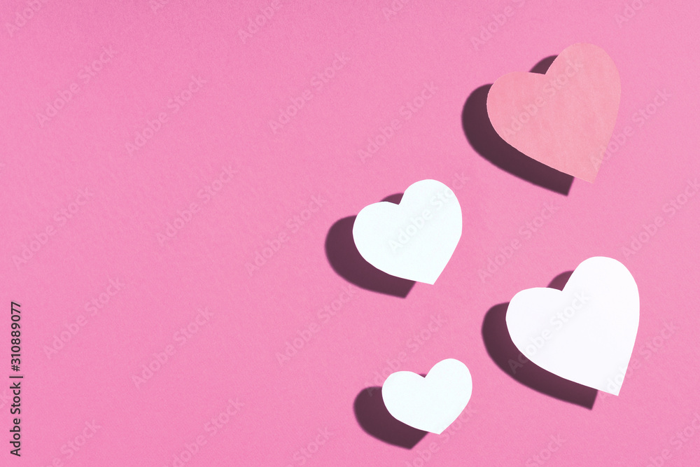 Valentine's day frame composition. Pink paper hearts on pink background. Top view, flat lay, copy space