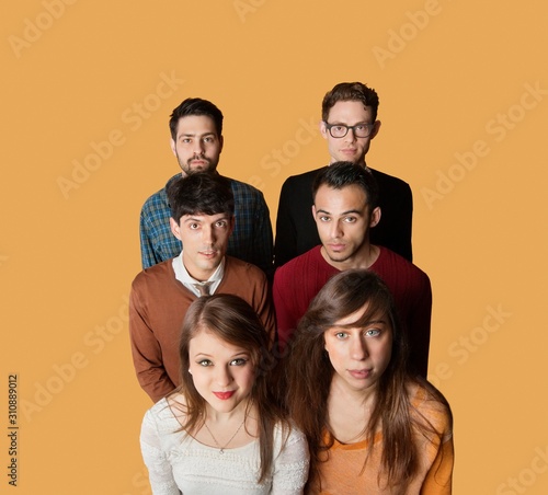 Portrait of multiethnic group of friends over colored background
