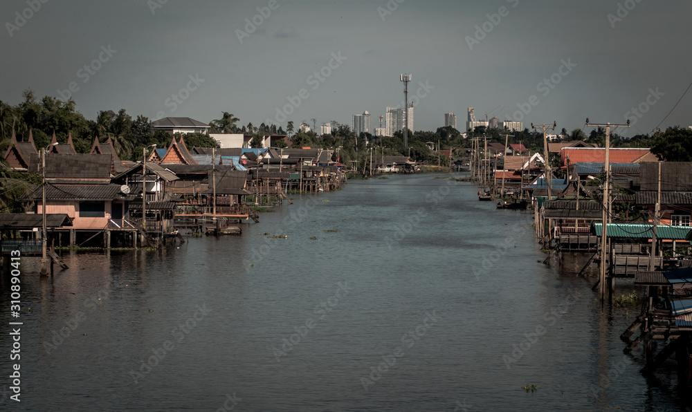 boat for travel in canal,Bangkok Thailand. Community canal in Bangkok Thailand . Thai traditional houses along canal .Thai lifestyle .travel destination boat for travel in canal,Bangkok Thailand. Community canal in Bangkok Thailand . Thai traditional houses along canal .Thai lifestyle .travel destination