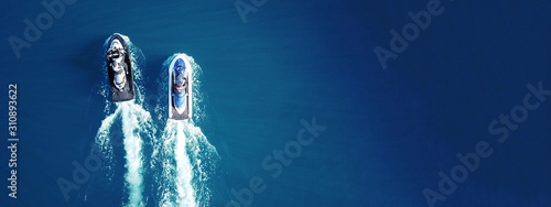 Vászonkép Aerial drone top view of jet skis cruising in deep blue sea