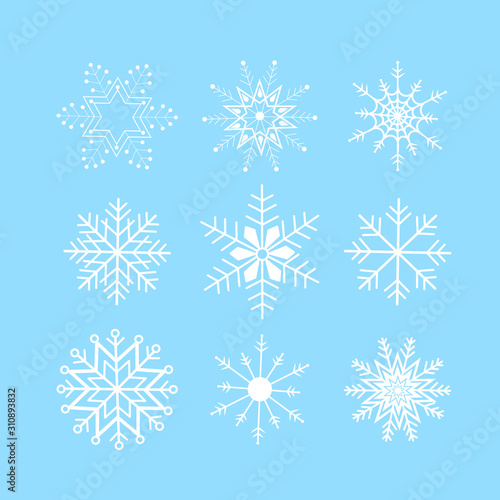 Set of abstract ice crystal snow flakes on blue background. Winter pattern