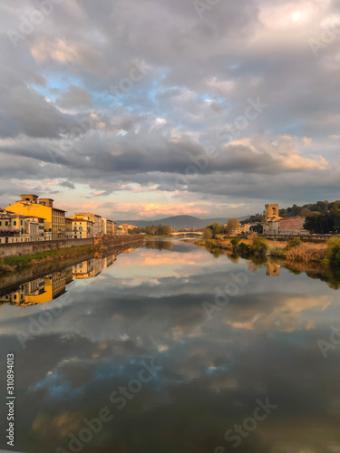 Clouds reflected in the Arno river in the city of Florence