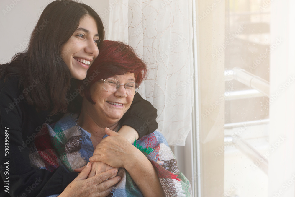 Woman hugging mother with love Woman hugging mother with love