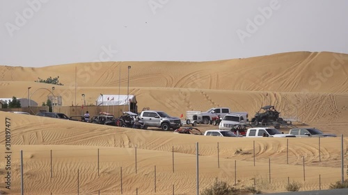 Tawi Nazwa, Dubai, United Arab Emirates - Vehicles and commuters stopover in the middle of the deserted place - Wide shot photo