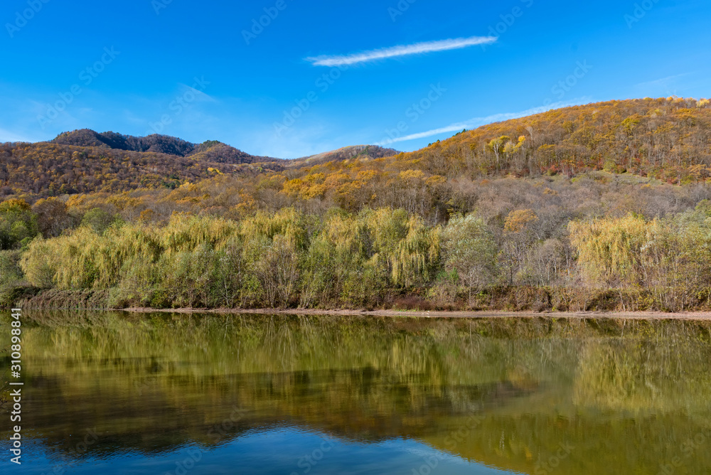 Beautiful autumn landscape with peaceful lake in North Caucasus