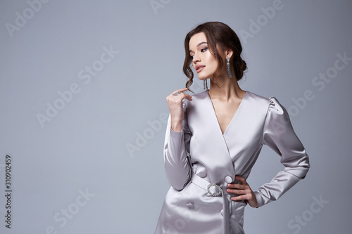 Canvas Print Beautiful sexy young business woman brunette hair with evening makeup wearing a dress white silk and high-heeled shoes fashion clothes for date party romantic collection perfect body shape