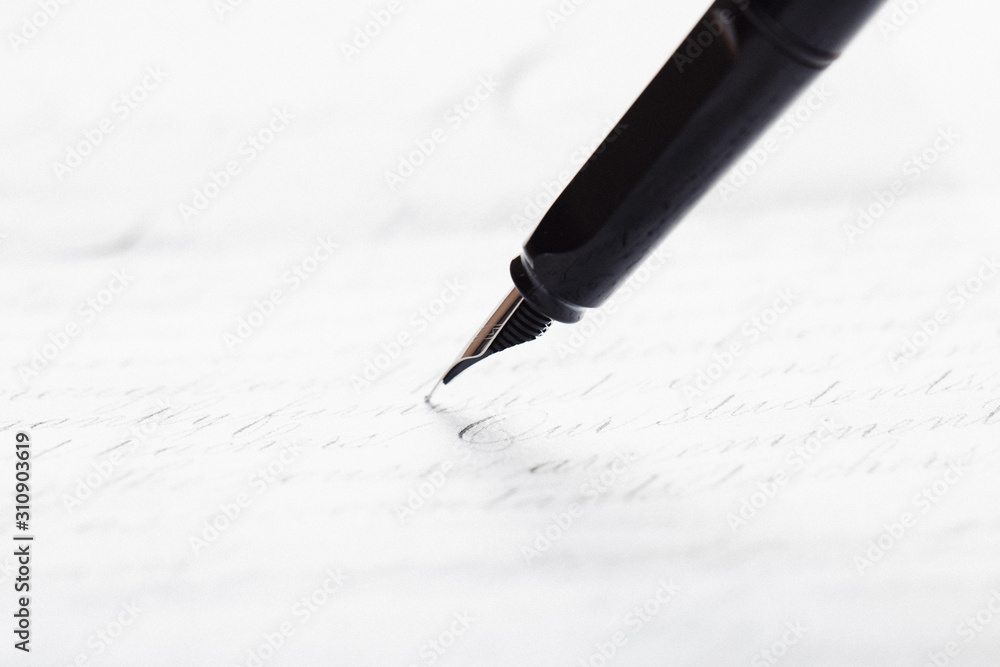 Fototapeta premium Fountain pen on an ancient handwritten letter. Old story. Retro style.