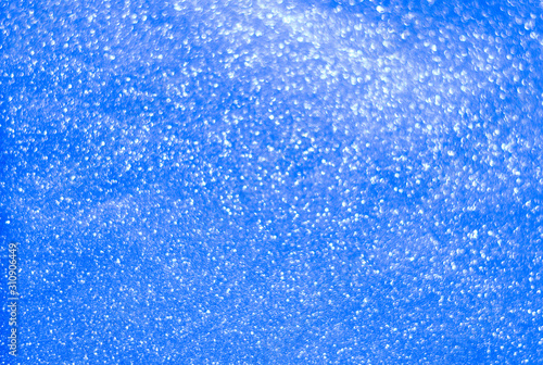 Abstract shiny blue Christmas background. Background for holiday cards. Blur, bokeh.