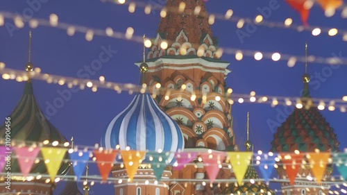 St. Basil's Cathedral or Cathedral of Vasily the Blessed or Cathedral of the Intercession of the Most Holy Theotokos on the Moat or Pokrovsky Cathedral many small colorful flags swaying in the wind