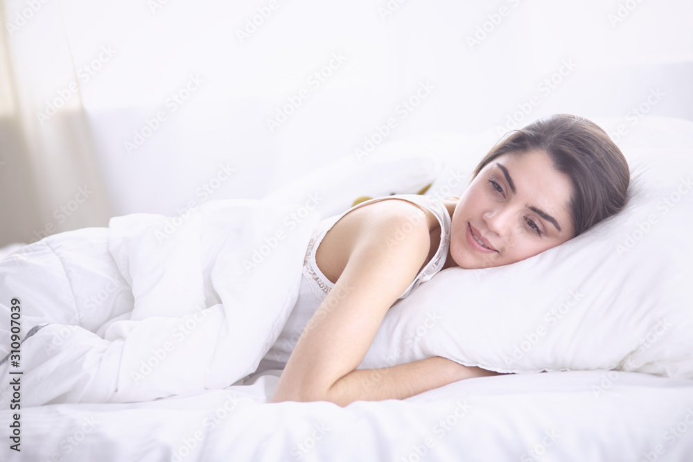 beautiful young woman basking in bed in the morning. Beautiful beautiful young woman basking in bed in the morning. Beautiful