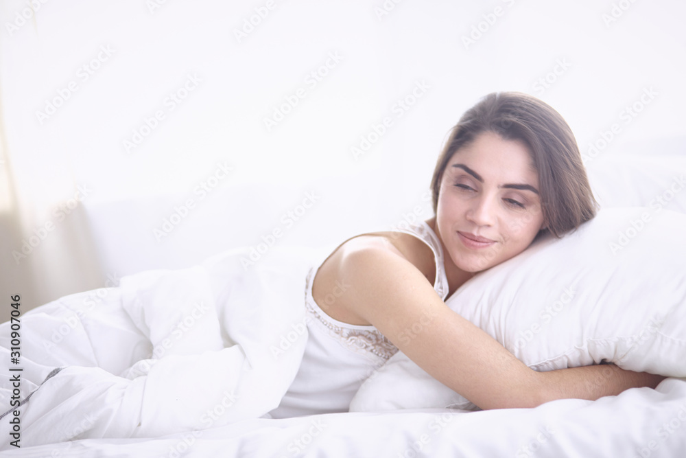 beautiful young woman basking in bed in the morning. Beautiful beautiful young woman basking in bed in the morning. Beautiful