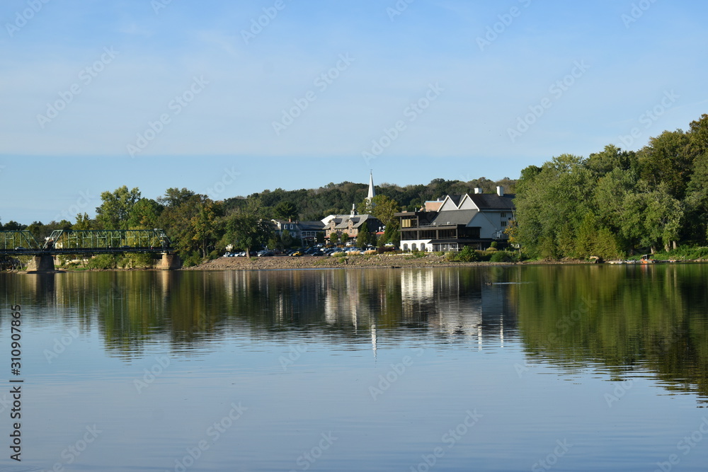 reflections of buildings on a calm river reflections of buildings on a calm river