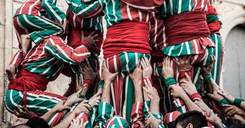 People working as a team building a human tower photo