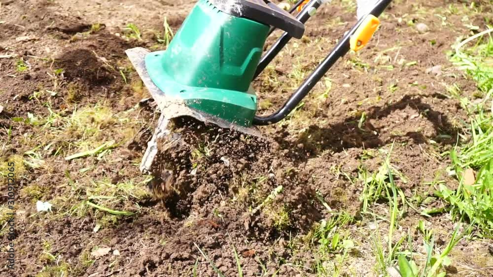 Plowing the land with an electric cultivator Plowing the land with an electric cultivator