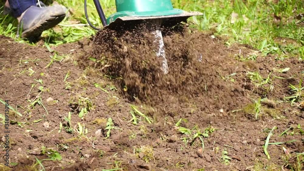 Plowing the land with an electric cultivator Plowing the land with an electric cultivator