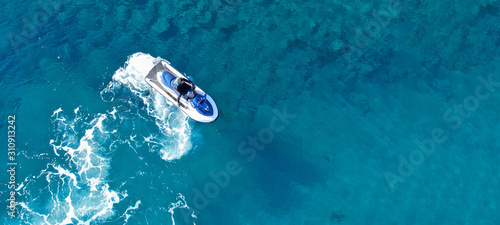 Aerial drone ultra wide top view photo of jet ski water craft cruising in deep blue Mediterranean sea © aerial-drone