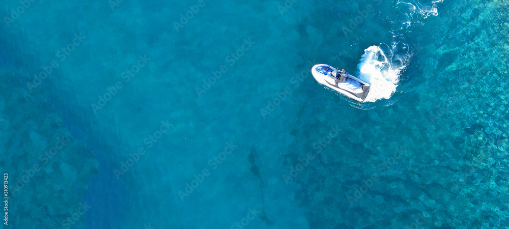 Aerial drone ultra wide top view photo of jet ski water craft cruising in deep blue Mediterranean sea Aerial drone ultra wide top view photo of jet ski water craft cruising in deep blue Mediterranean sea