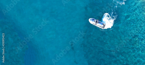 Aerial drone ultra wide top view photo of jet ski water craft cruising in deep blue Mediterranean sea