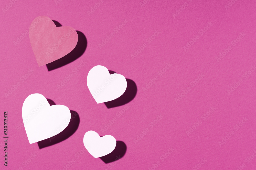 Valentine's day frame composition. Pink white paper hearts on purple background. Top view, flat lay, copy space Valentine's day frame composition. Pink white paper hearts on purple background. Top view, flat lay, copy space