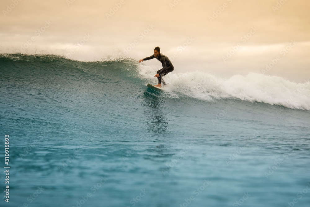surfer riding waves on the island of fuerteventura