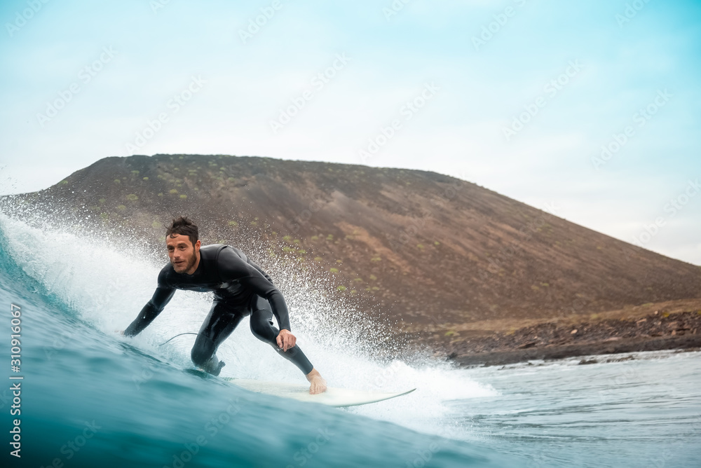 surfer riding waves on the island of fuerteventura surfer riding waves on the island of fuerteventura