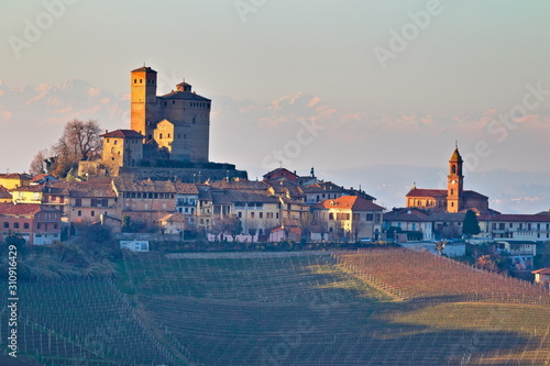 Winter view at golden hour of Serralunga D'Alba village and its castle, in the famus Langhe region, Cuneo, Piedmont, Italy photo