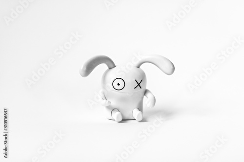 Figure of a funny white rabbit on a white background