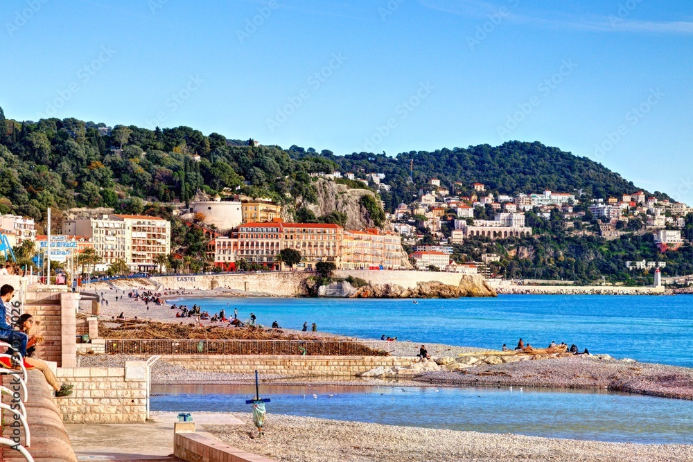 Nice, France - December 1, 2019: view of the beach and walkway promenade on a clear winter day