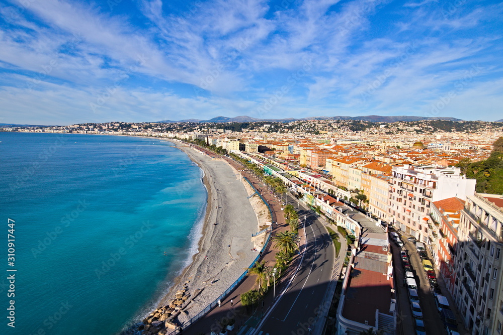 Panoramic view on a winter morning with blue sky on the Nice waterfront, Promenade Des Anglais, and old town, from the castle garden