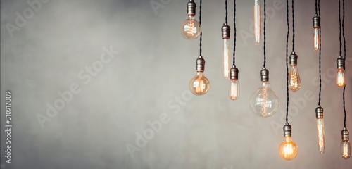 Edison lamp is included in loft room, against background of concrete wall photo