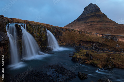 The iconic Kirkjufell waterfall during early gloomy morning. This waterfall is the most iconic waterfall in Iceland. 