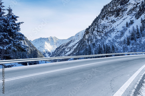 Winter background of road and mountains landscape 