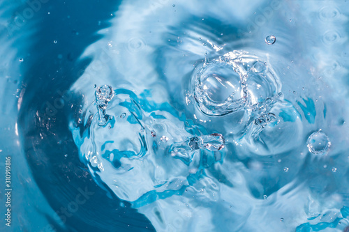 Splash of water close-up. Water drop. A blue drop of water. Falling water. The rain closeup. Blue background