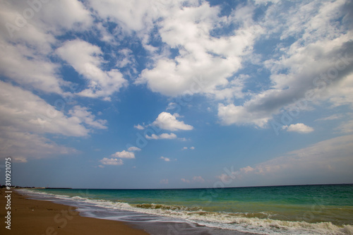 Fototapeta Naklejka Na Ścianę i Meble -  sandy ocean shore, sky and clouds