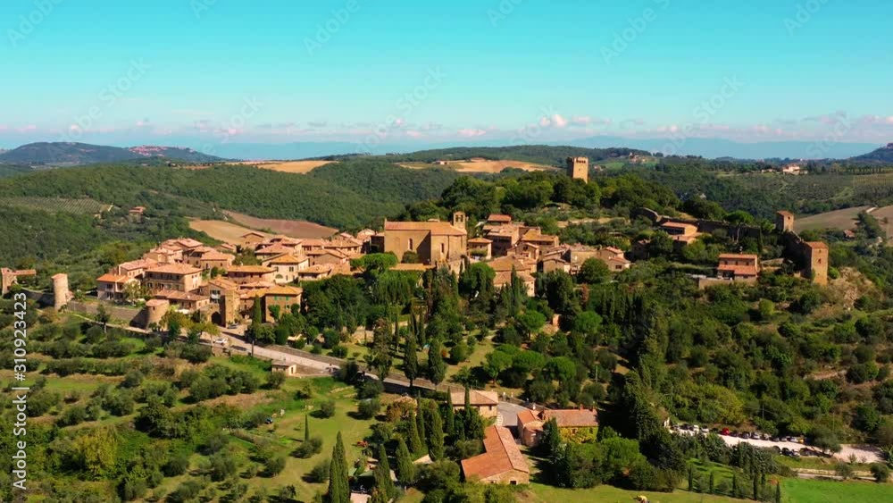 An Italian village with green meadows all over the village. Aerial view with a drone of the beautiful and old village of Monticchiello in Tuscany, Italy An Italian village with green meadows all over the village. Aerial view with a drone of the beautiful and old village of Monticchiello in Tuscany, Italy