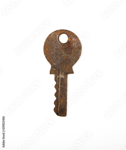 One single metal vintage rusty antique key isolated on white background. Home security concept.