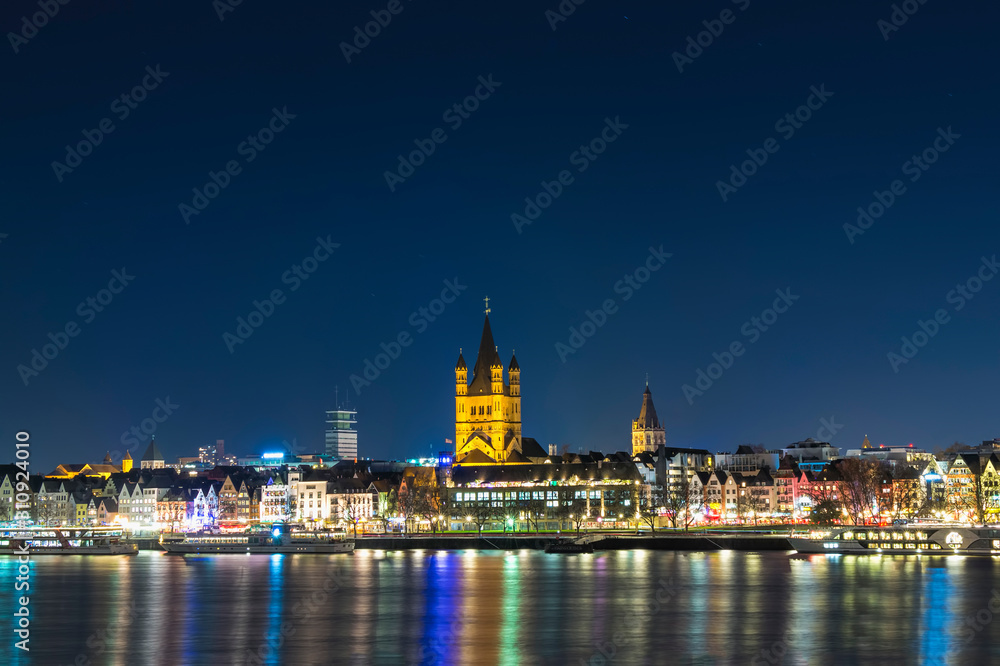 River Rhine with illuminated Cologne Old Town and church of Gross St. Martin